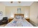 Bright bedroom featuring a decorative quilt, wooden furniture and ambient bedside lighting at 992 S Roanoke St, Gilbert, AZ 85296