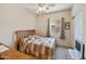 Cozy bedroom with natural light, ceiling fan, and a quaint decorative quilt at 992 S Roanoke St, Gilbert, AZ 85296