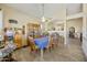 Dining room has a large table with a blue tablecloth, and glass shelving at 992 S Roanoke St, Gilbert, AZ 85296