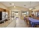 Kitchen flows into the dining room with a large dining table set for guests at 992 S Roanoke St, Gilbert, AZ 85296