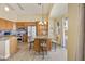 Bright kitchen with wood cabinets, granite counters, stainless appliances, island, and breakfast nook at 992 S Roanoke St, Gilbert, AZ 85296
