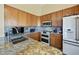 Granite countertop on wood cabinets with stainless appliances and tile backsplash at 992 S Roanoke St, Gilbert, AZ 85296