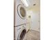 A well-lit laundry room featuring a stackable washer and dryer at 992 S Roanoke St, Gilbert, AZ 85296
