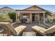 Charming patio with brick flooring, comfortable lounge chairs and covered seating area with outdoor furnishings at 992 S Roanoke St, Gilbert, AZ 85296
