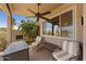 Cozy patio area featuring comfortable seating, an outdoor ceiling fan, and a grill for outdoor entertaining at 992 S Roanoke St, Gilbert, AZ 85296