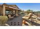 A backyard patio featuring comfortable seating, a pool and lush landscaping at 992 S Roanoke St, Gilbert, AZ 85296