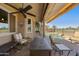Covered patio featuring outdoor seating, an awning, and views of the pool and palm trees at 992 S Roanoke St, Gilbert, AZ 85296
