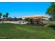 Community playground area on green lawn with mature trees and shade canopies at 992 S Roanoke St, Gilbert, AZ 85296