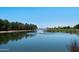 Picturesque pond with a fountain, surrounded by trees, and clear blue sky at 992 S Roanoke St, Gilbert, AZ 85296