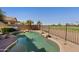 Backyard pool surrounded by lush landscaping and views of a golf course beyond the fence at 992 S Roanoke St, Gilbert, AZ 85296