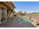 This beautiful pool features custom rock detail, a golf course view and a private patio area, perfect for relaxing at 992 S Roanoke St, Gilbert, AZ 85296