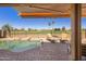 Relax poolside with stunning golf course views from this backyard oasis featuring custom rock details and loungers at 992 S Roanoke St, Gilbert, AZ 85296