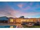 Inviting backyard with pool, lounge chairs, patio seating and string lights; perfect for outdoor entertaining at 10007 N 30Th Pl, Phoenix, AZ 85028