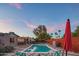 Beautiful backyard featuring a sparkling pool, mature landscaping, and a vibrant atmosphere at 10007 N 30Th Pl, Phoenix, AZ 85028