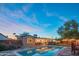 Stunning backyard with a sparkling pool, lush greenery, and stylish outdoor lighting at twilight at 10007 N 30Th Pl, Phoenix, AZ 85028
