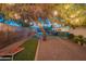 Backyard with a cornhole area, gravel paths, and festive string lighting at 10007 N 30Th Pl, Phoenix, AZ 85028