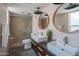 Modern bathroom featuring double sinks, a shower with glass door and sleek fixtures at 10007 N 30Th Pl, Phoenix, AZ 85028