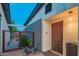 Inviting entrance featuring a modern wood door, unique brickwork, and tranquil water feature at 10007 N 30Th Pl, Phoenix, AZ 85028