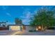 Charming mid-century modern home with desert landscaping and a sleek, modern garage door at 10007 N 30Th Pl, Phoenix, AZ 85028