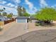 Stunning curb appeal with desert landscaping and a modern gray garage door in this charming home at 10007 N 30Th Pl, Phoenix, AZ 85028