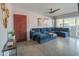 Comfortable living room with a plush blue sectional, contemporary decor, and sliding glass doors to a patio at 10007 N 30Th Pl, Phoenix, AZ 85028