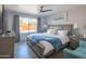 Spacious bedroom features a ceiling fan, large window and modern furnishings at 10007 N 30Th Pl, Phoenix, AZ 85028