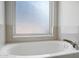 Inviting bathtub with chrome faucet set below a privacy window letting in the room's natural light at 10215 W Missouri Ave, Glendale, AZ 85307