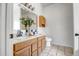 Bright bathroom featuring double sinks, a large mirror, and blue and white backsplash tile at 10215 W Missouri Ave, Glendale, AZ 85307