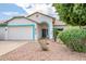 Attractive single-story home with turquoise trim, desert landscaping, and attached garage at 10215 W Missouri Ave, Glendale, AZ 85307