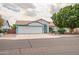 Charming single-story home boasts a three-car garage, desert landscaping and freshly painted trim at 10215 W Missouri Ave, Glendale, AZ 85307
