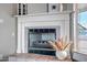 Close-up of the fireplace showcasing a white mantle, decorative vases, and tile surround at 10215 W Missouri Ave, Glendale, AZ 85307