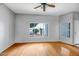 Bright living room featuring wood floors, a ceiling fan, and a view of the front yard at 10215 W Missouri Ave, Glendale, AZ 85307