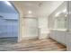 This bathroom features a glass-enclosed shower, double vanity, and wood-look floors at 10465 E Dutchmans Trl, Gold Canyon, AZ 85118