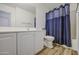 Bathroom features a single-sink vanity with white cabinets and modern fixtures and a shower with blue curtain at 10465 E Dutchmans Trl, Gold Canyon, AZ 85118