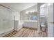 Bright bathroom featuring a walk-in shower, double vanity, and wood-look flooring at 10465 E Dutchmans Trl, Gold Canyon, AZ 85118