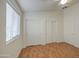 This bedroom features wood-look floors, a window, and closet with sliding doors at 10465 E Dutchmans Trl, Gold Canyon, AZ 85118