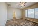 The bright bedroom includes wood-look flooring, a ceiling fan, and a window at 10465 E Dutchmans Trl, Gold Canyon, AZ 85118