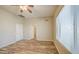Bright bedroom features wood-look flooring, ceiling fan and an open door to the bathroom at 10465 E Dutchmans Trl, Gold Canyon, AZ 85118