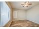 Bedroom featuring wood-look floors, ceiling fan, and two windows with blinds at 10465 E Dutchmans Trl, Gold Canyon, AZ 85118