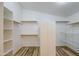 Walk-in closet with built-in shelves, hanging rods, and wood-look floors at 10465 E Dutchmans Trl, Gold Canyon, AZ 85118