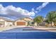 Lovely single-level home with an attached two-car garage and low-maintenance front yard at 10465 E Dutchmans Trl, Gold Canyon, AZ 85118