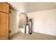 Garage area featuring cabinets and shelving for storage solutions, water filtration system at 10465 E Dutchmans Trl, Gold Canyon, AZ 85118