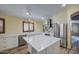 Bright kitchen features white cabinets, marble countertops, stainless steel appliances and central island at 10465 E Dutchmans Trl, Gold Canyon, AZ 85118
