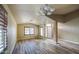 Bright living room featuring hardwood floors, neutral paint, and window shutters at 10465 E Dutchmans Trl, Gold Canyon, AZ 85118