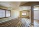 Well-lit living room featuring hardwood floors, window shutters, and neutral wall paint at 10465 E Dutchmans Trl, Gold Canyon, AZ 85118