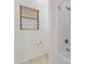 Bright bathroom with a window and a shower with new fixtures, and light tile flooring at 10758 E Lobo Ave, Mesa, AZ 85209