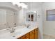 Bathroom with dual sinks and shower at 10758 E Lobo Ave, Mesa, AZ 85209