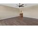 An expansive bedroom with wood floors, fan and neutral paint at 10758 E Lobo Ave, Mesa, AZ 85209