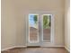 Bright carpeted bedroom with a fan and sliding glass doors with white trim and horizontal blinds at 10758 E Lobo Ave, Mesa, AZ 85209
