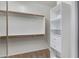 Spacious walk-in closet with shelving and hanging rods for optimal organization and storage at 10758 E Lobo Ave, Mesa, AZ 85209